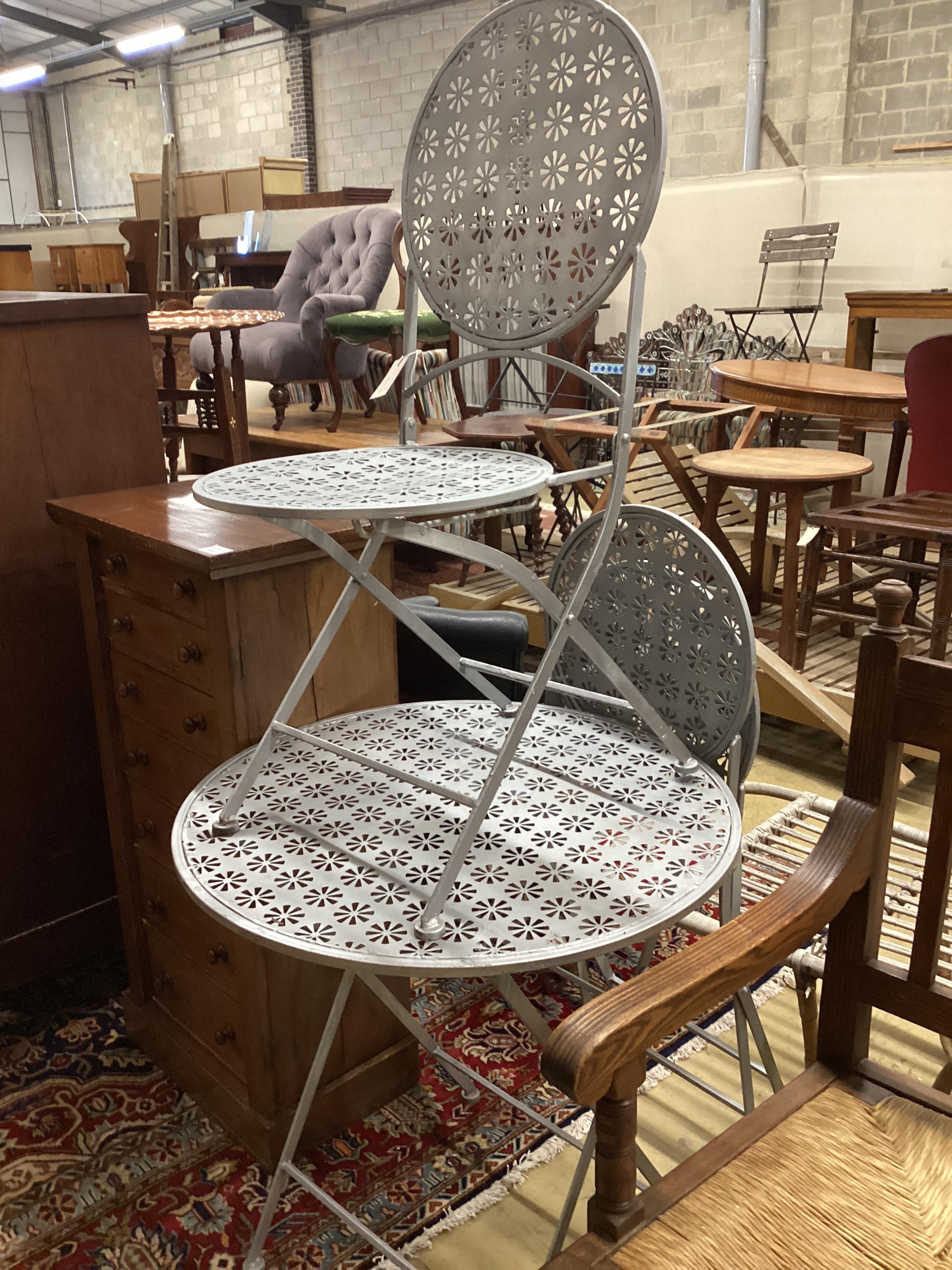 A metal garden table, diameter 72cm, height 75cm and two chairs
